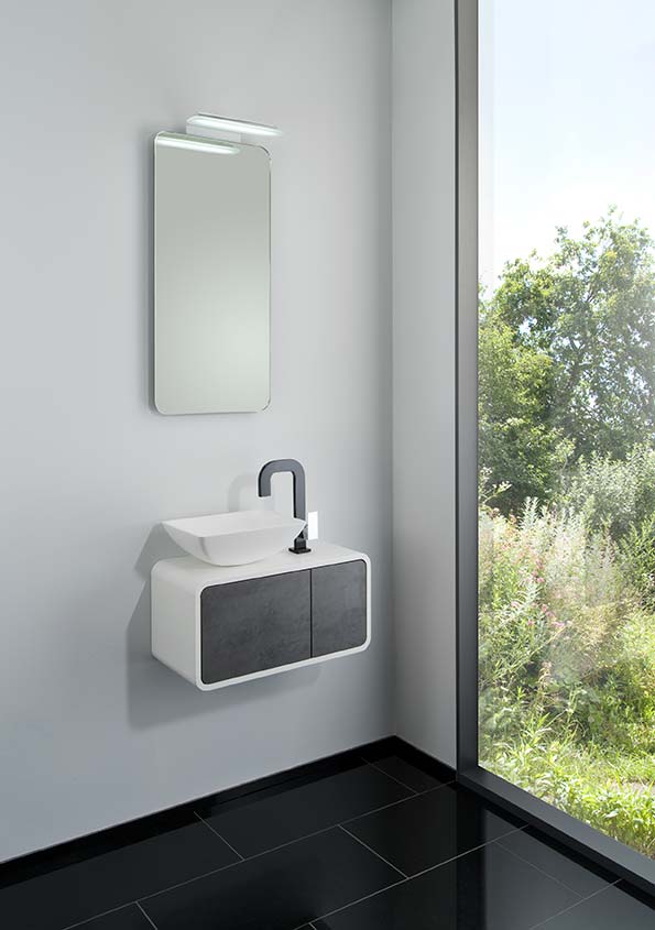 Modernes Handwaschbecken mit Unterschrank in schwarz-weiß und abgerundeten Ecken